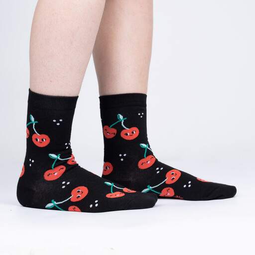 Black socks with cute cartoon red cherries with smiley faces.