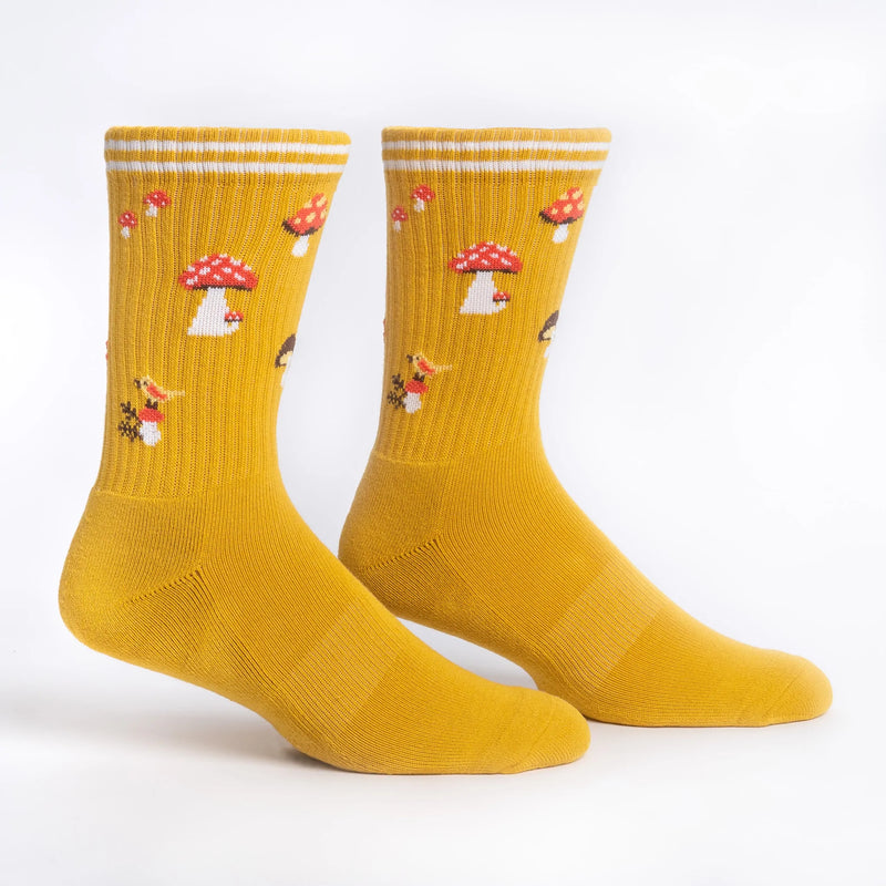 Mustard yellow tube socks with red and white mushrooms and birds.