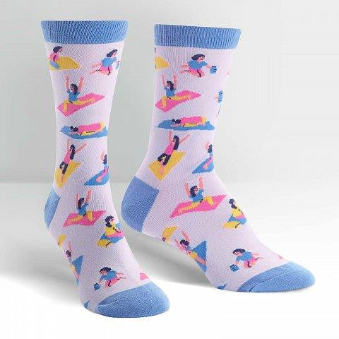 Pastel purple and periwinkle socks with people doing different yoga positions in pink, navy and yellow.