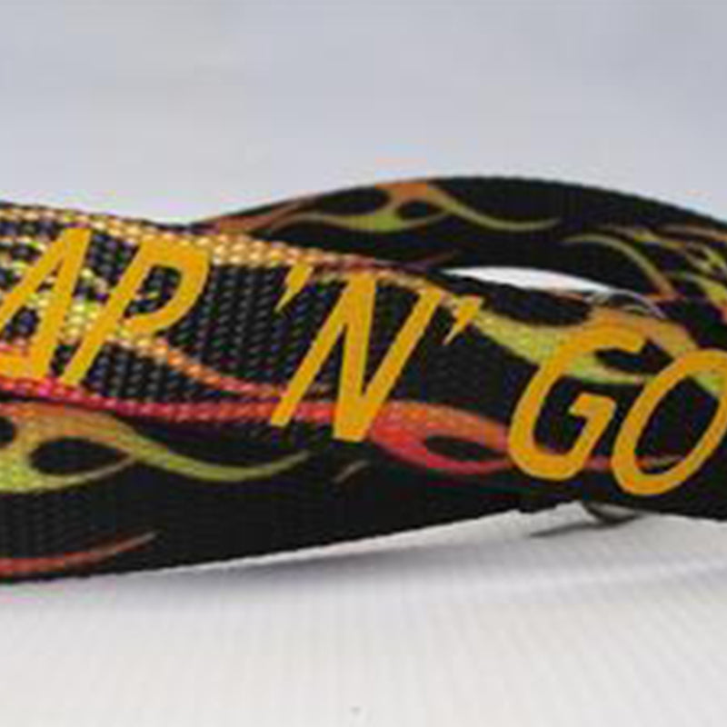Strap N Go skate leash in black with yellow and orange print.